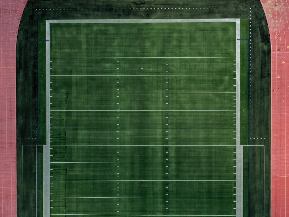 An aerial view of an empty football field at Towson University in Towson, Md. Many colleges rely on summer camps for additional revenue during the summer.