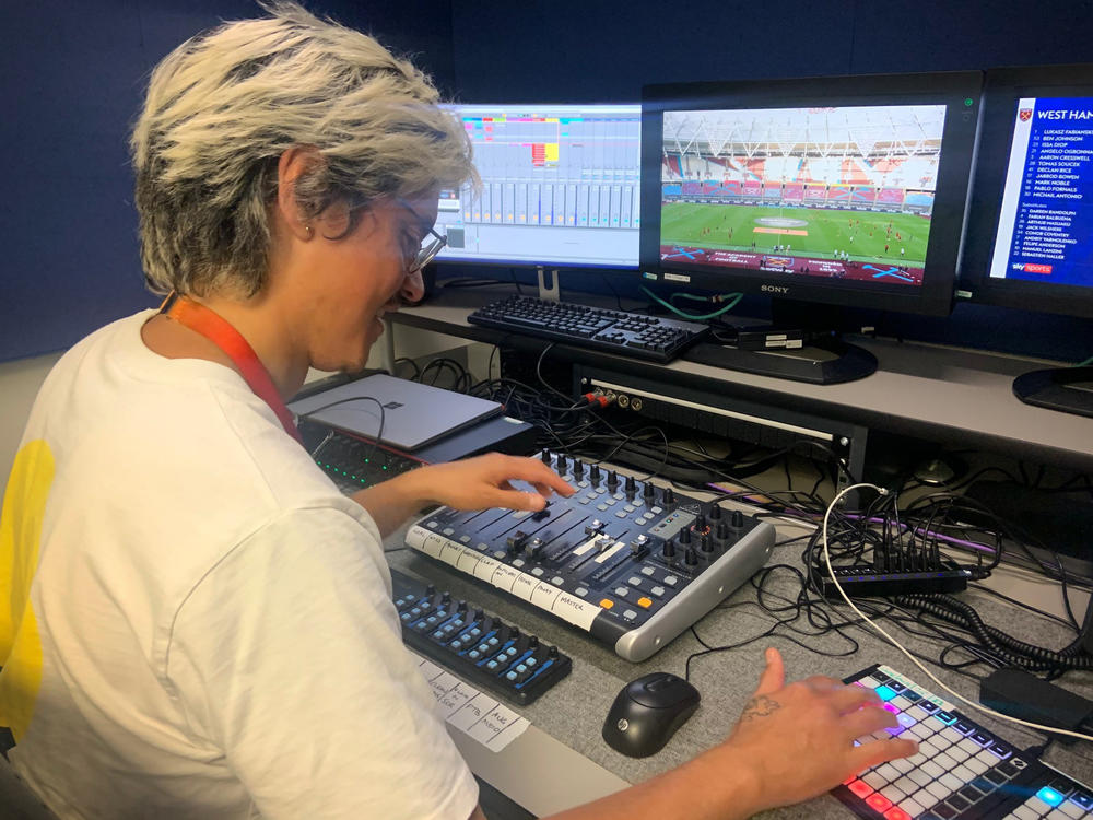 Adam Peri, sound supervisor with the broadcaster Sky UK, mixes recorded fan sounds into a Premier League soccer match.