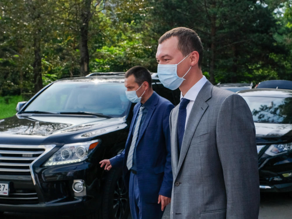 The acting governor of the Khabarovsk region, Mikhail Degtyaryov (right), visits a local hospital on Thursday. Russian President Vladimir Putin appointed him earlier this month. On his first night on the job, protesters chanted, 