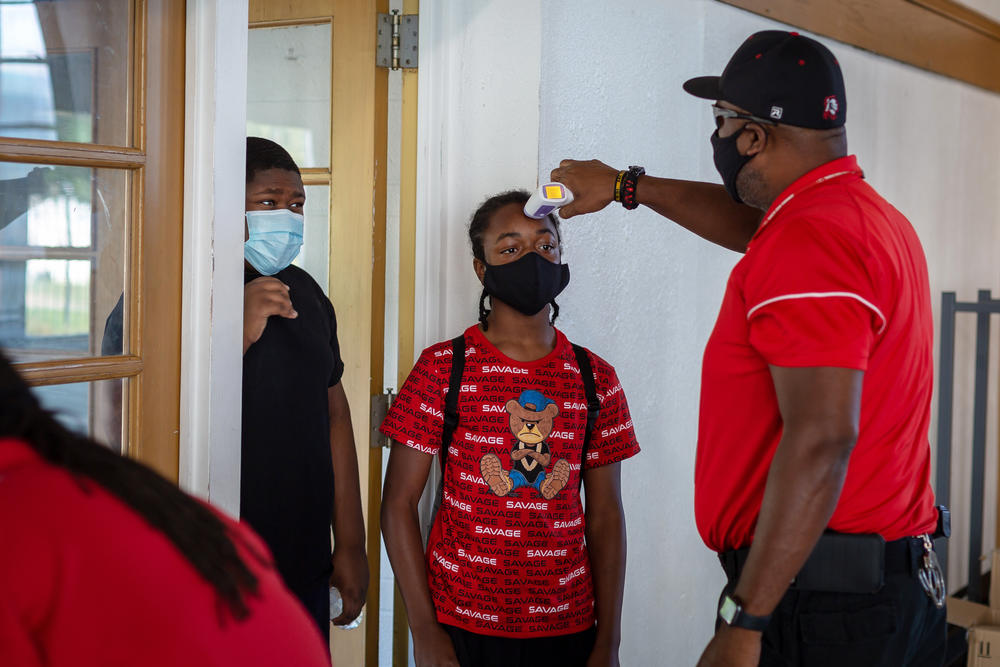 Students who attend the summer enrichment program in Jennings, Mo., have their temperature taken upon arrival.