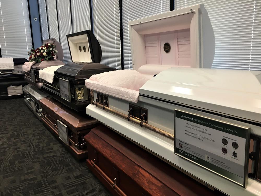 Caskets on display at Serenity Funeral Home in Kansas City, Mo., where many of the city's homicide victims are memorialized.