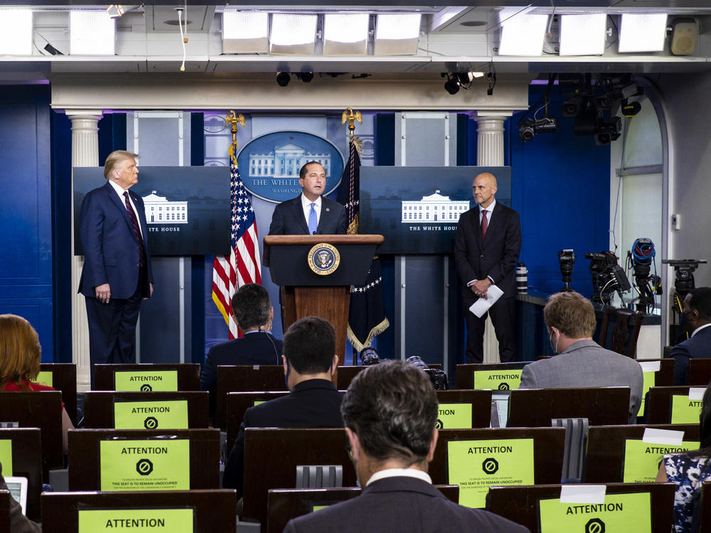 President Donald Trump, left, FDA Commissioner Stephen Hahn, right, and Health and Human Services Secretary Alex Azar, center, announced at a news conference on Sunday that the FDA issued emergency use authorization for convalescent plasma as a COVID-19 treatment.