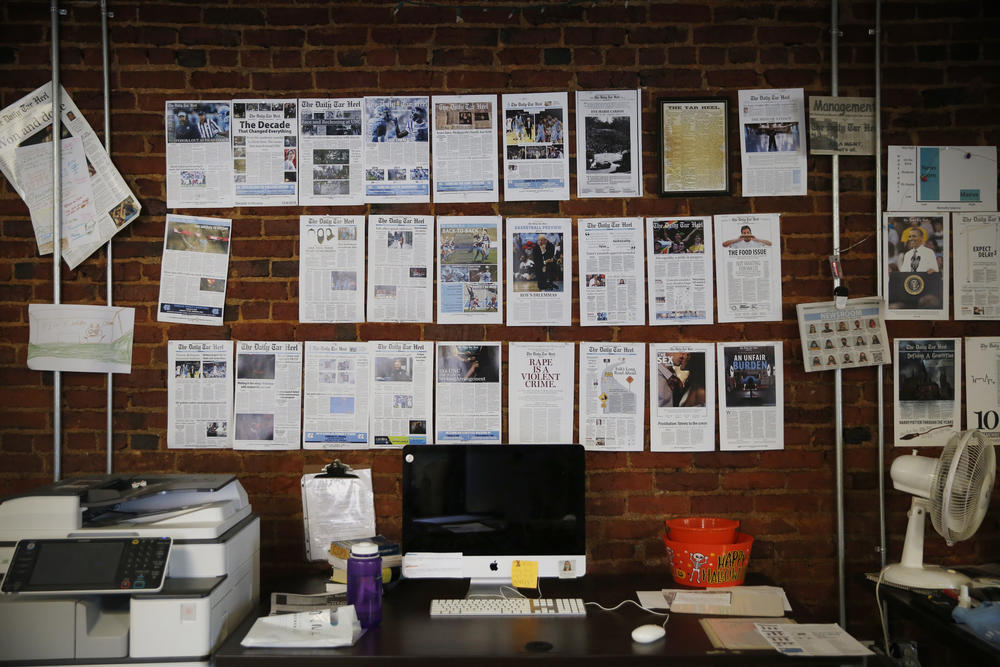 A wall in <em>The Daily Tar Heel</em>'s newsroom is lined with memorable headlines.
