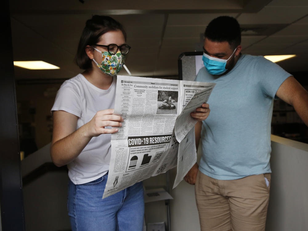 Student journalists Anna Pogarcic and Brandon Standley of UNC's <em>Daily Tar Heel</em> review a recent issue at their offices off campus.