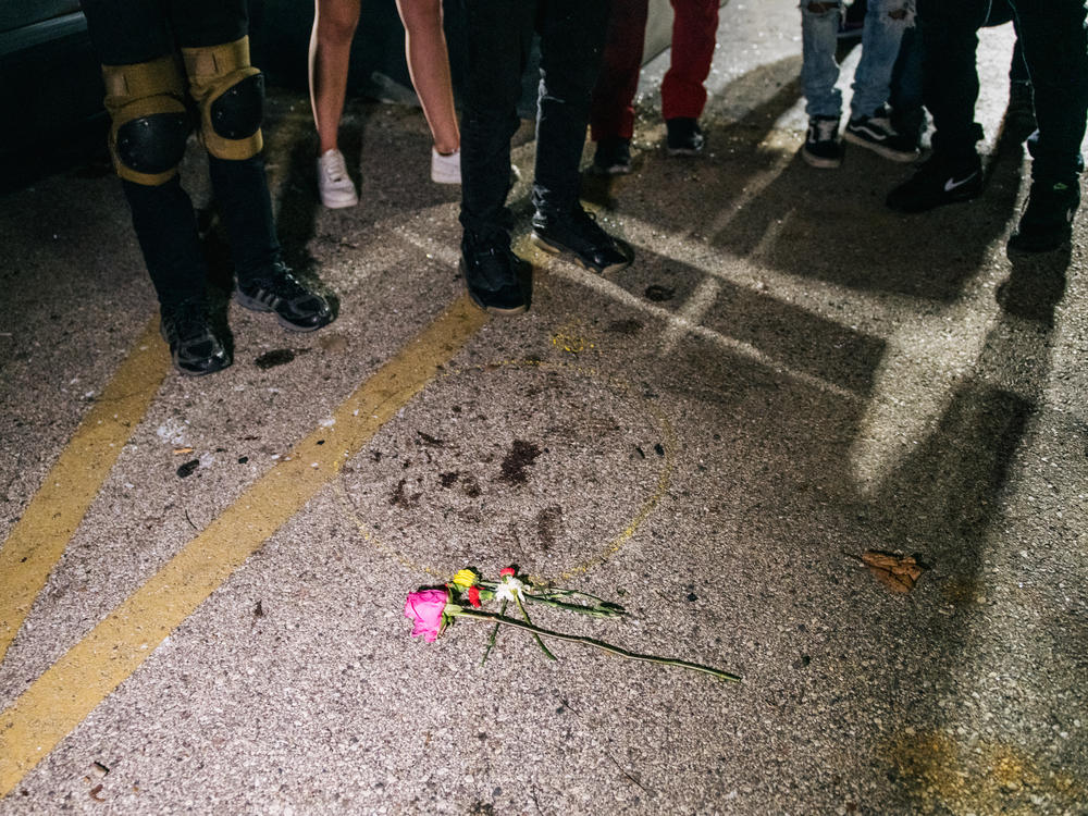 Demonstrators revisit the site where a protester was killed in Kenosha, Wis. On Aug. 25, 17-year-old Kyle Rittenhouse shot and killed two protesters. He was charged on Thursday with six criminal counts, including first-degree intentional homicide.