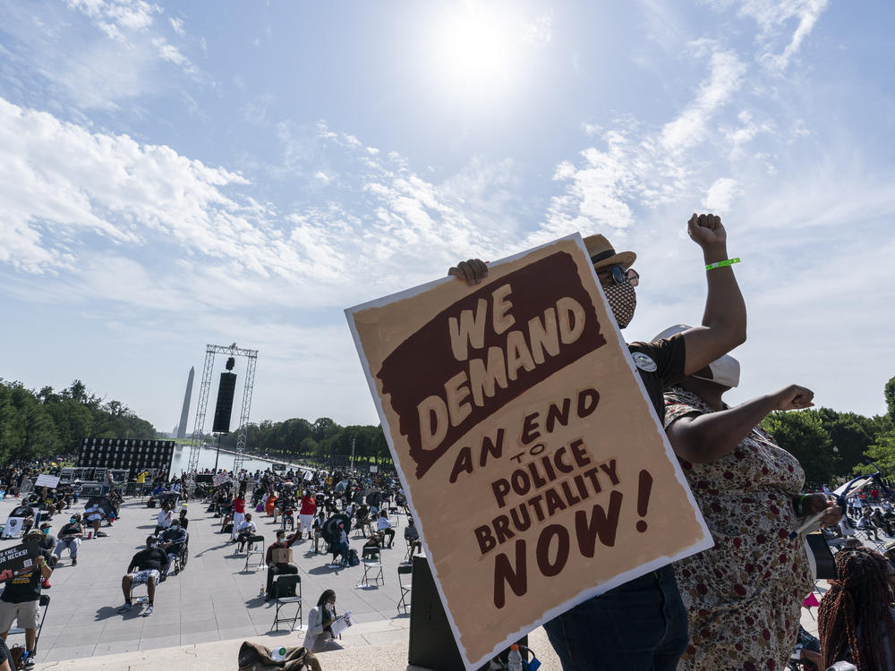 People attend the March on Washington, on Friday at the Lincoln Memorial in Washington, D.C., on the 57th anniversary of the Rev. Martin Luther King Jr.'s 