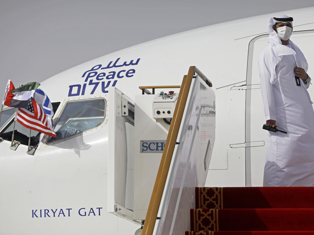 An official stands at the door of an Israeli El Al airliner after it landed in Abu Dhabi, United Arab Emirates, on Monday after flying in from Tel Aviv.