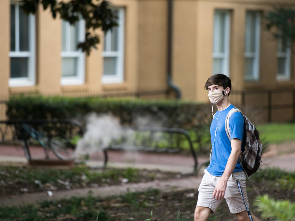 A student walks on campus at the University of South Carolina. During the final week of August, the university reported a 26.6% positivity rate among the student population tested for the coronavirus.