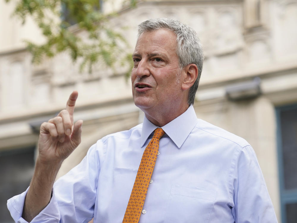New York City Mayor Bill de Blasio, shown here last month in Brooklyn, says that he and employees in his office will take furloughs to reduce costs.