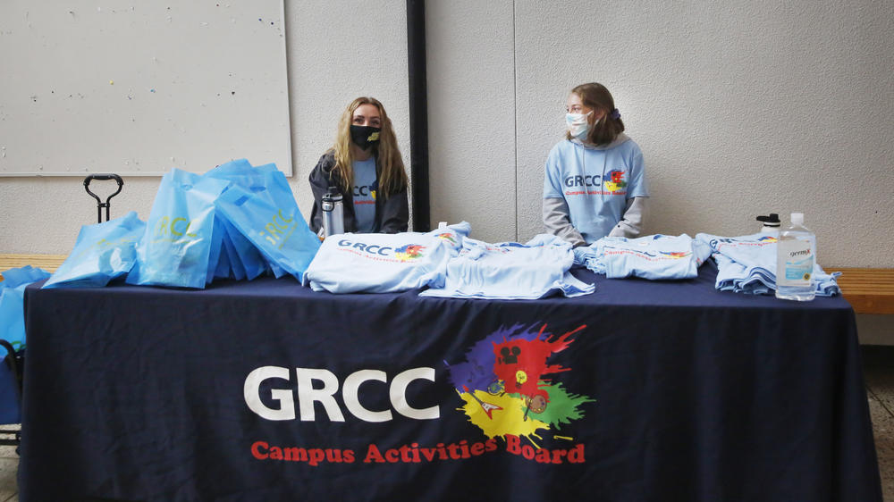 Students at Grand Rapids Community College pass out T-shirts to promote virtual student life offerings during the fall semester.