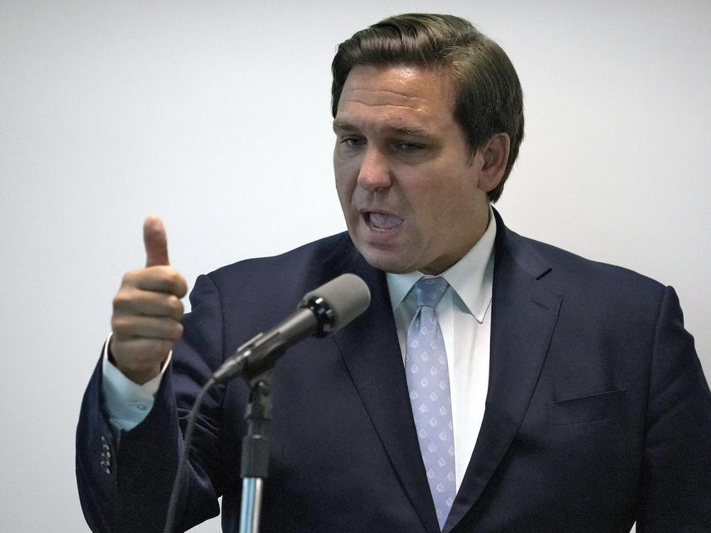 Florida Gov. Ron DeSantis, here during a news conference last month, says his state is ready to respond if a surge of coronavirus infections emerges.