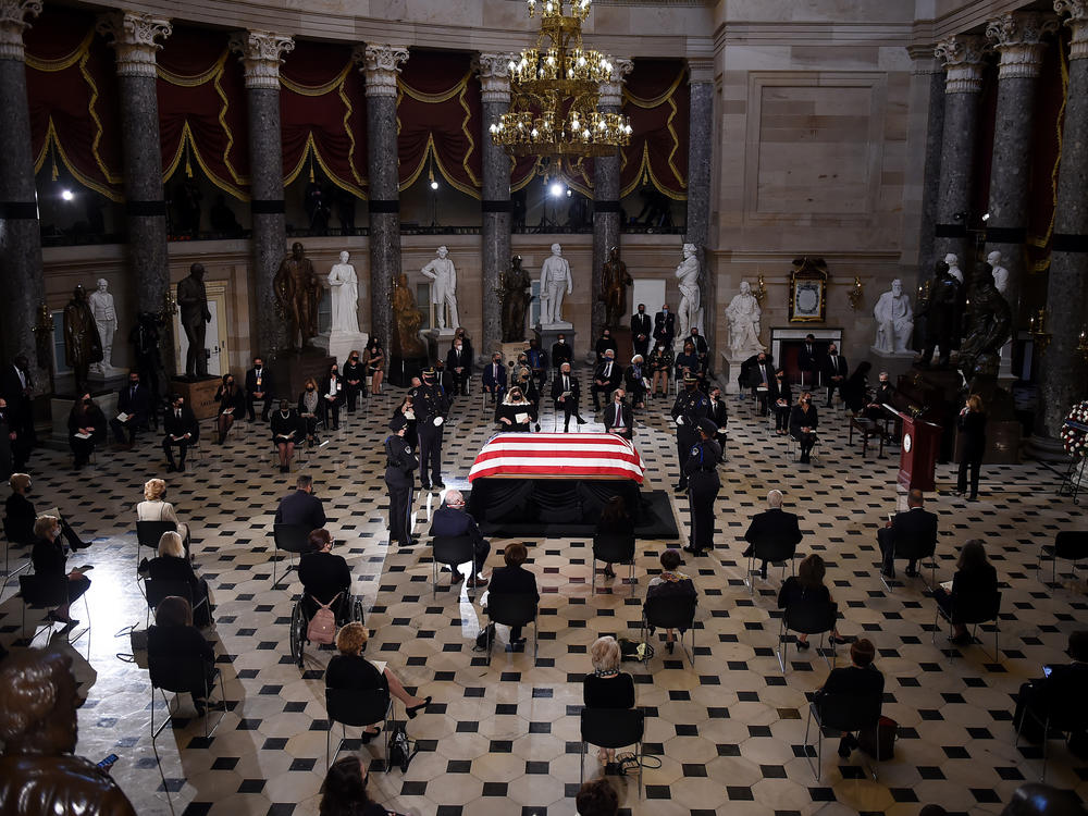 Members of Congress and guests pay their respects to the late Associate Justice Ruth Bader Ginsburg as her casket lies in state during a memorial service in her honor in Statuary Hall of the U.S. Capitol.