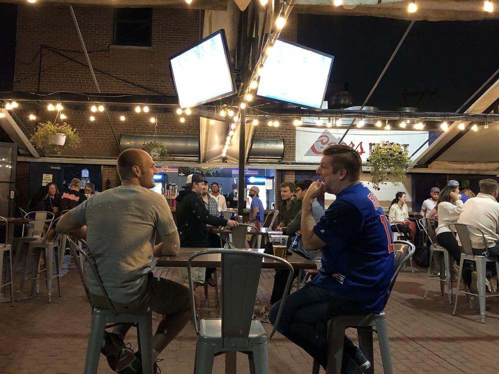 Sox fan Steve Nitz (left) and Cubs fan Paul Schmitz watch the crosstown rivals play each other last weekend in the beer garden at Bernie's Tap and Grill across the street from Wrigley Field in Chicago.