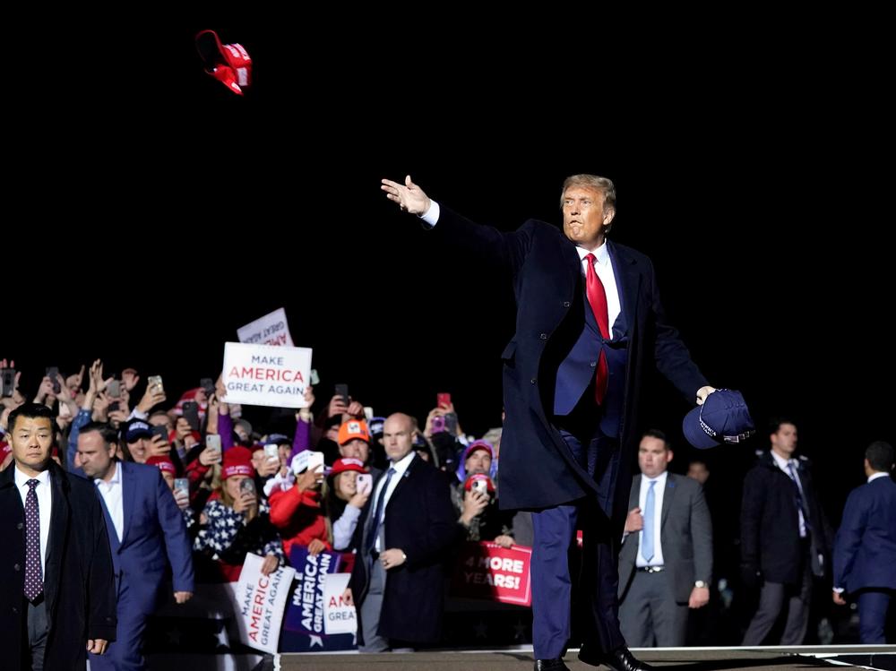 President Donald Trump throws hats to supporters after speaking Wednesday at a campaign rally at Duluth International Airport in Minnesota.