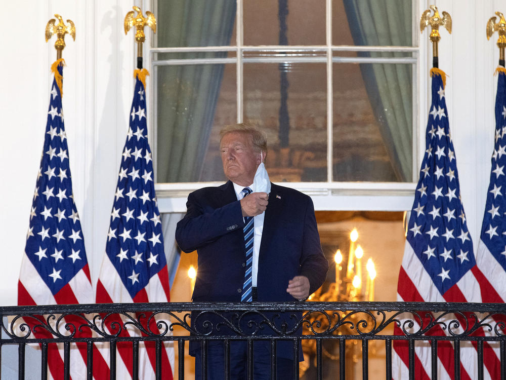 President Trump is seen removing his mask upon his return to the White House from Walter Reed National Military Medical Center on Monday, days after he tested positive for the coronavirus.