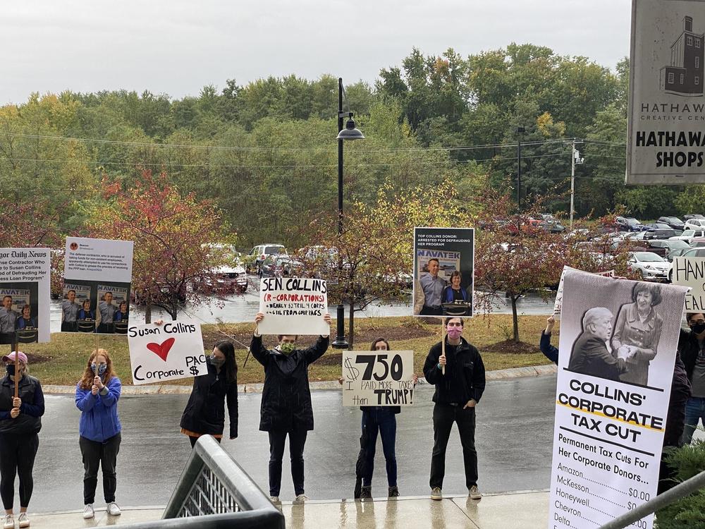 Protesters gather outside Lockwood Mills in Waterville, Maine, during a campaign visit from Sen. Susan Collins.