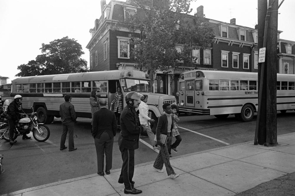 School desegregation continues at South Boston High School, Sept. 24, 1974, with Black students arriving by bus and white students walking from their neighborhood homes.