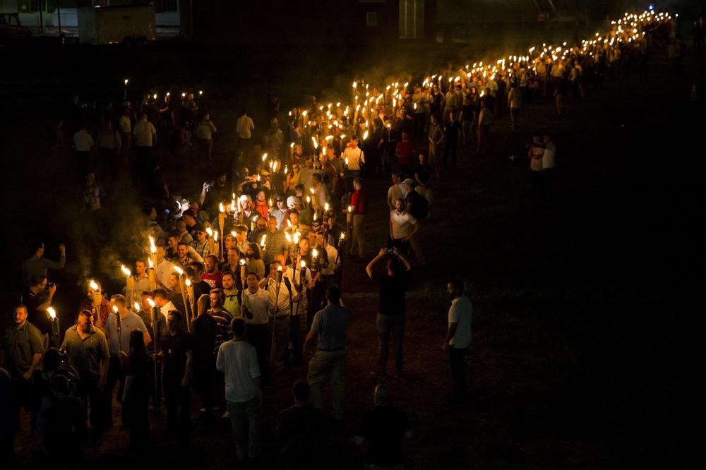 Neo-Nazis, alt-right and white supremacists march through the University of Virginia campus with torches in Charlottesville, Va., on Aug. 11, 2017.