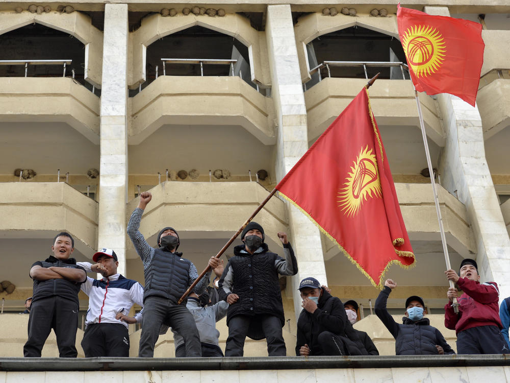 Supporters of Kyrgyzstan's Prime Minister Sadyr Japarov attend a rally in Bishkek, Kyrgyzstan, on Thursday. President Sooronbai Jeenbekov announced his resignation in a bid to end the turmoil that has engulfed the Central Asian nation after a disputed parliamentary election.
