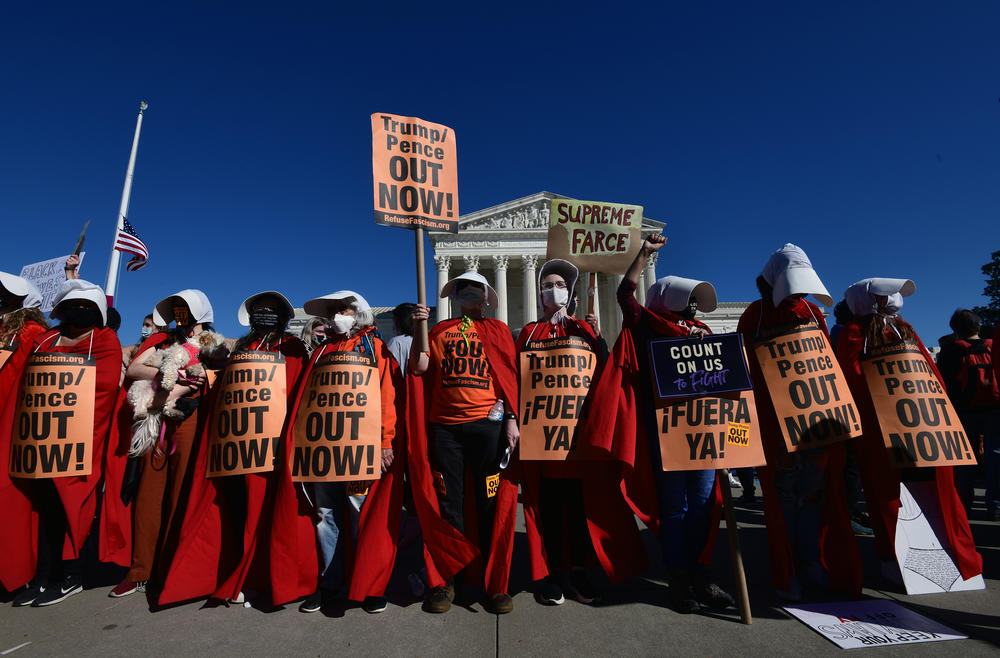 Women dressed as handmaidens to protest Supreme Court nominee Amy Coney Barrett.⁠⠀