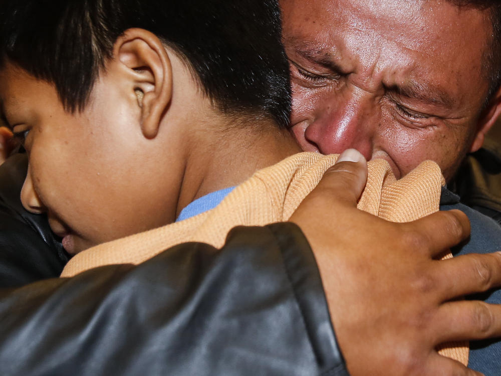 David Xol of Guatemala hugs his son Byron as they were reunited at Los Angeles International Airport in January. The father and son were separated 18 months earlier under the Trump administration's 