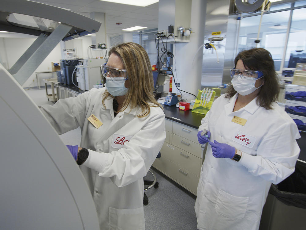Eli Lilly researchers prepare cells to produce possible COVID-19 antibodies in a laboratory in Indianapolis. The drugmaker has asked the U.S. government to allow emergency use of its experimental antibody therapy.