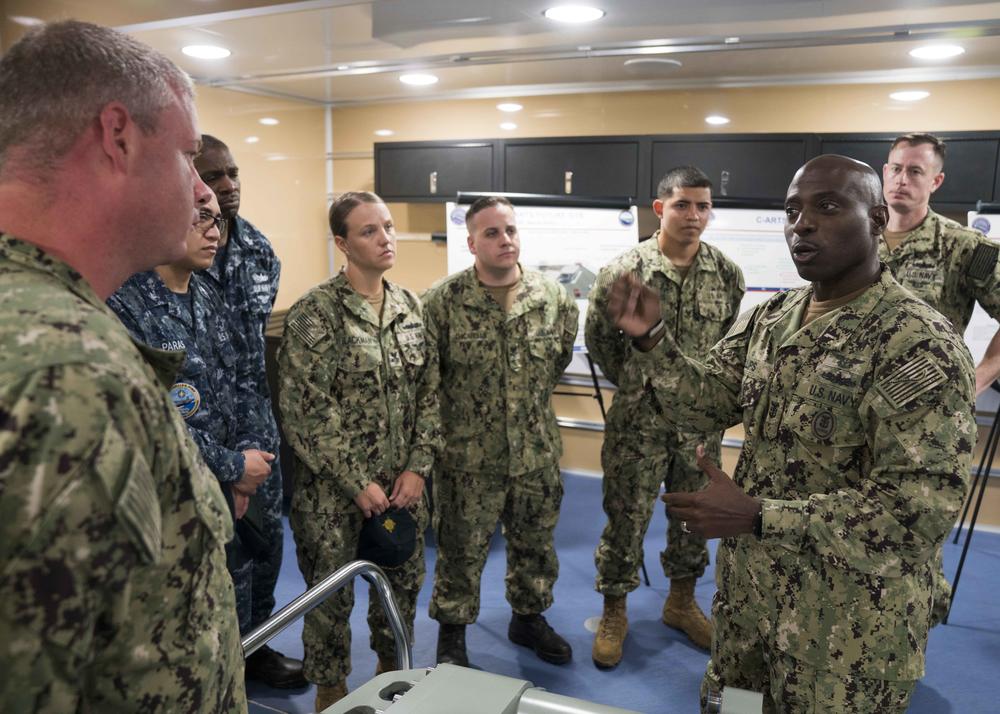 Commander, Naval Air Force Atlantic Force Master Chief Huben Phillips (right) speaks to Sailors from the aircraft carrier USS Gerald R. Ford after a Carrier-Advanced Reconfigurable Training Systems presentation in 2018.