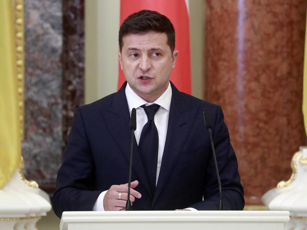 Ukrainian President Volodymyr Zelenskiy speaks during a joint news briefing with Polish President Andrzej Duda in Kyiv, last month. A spokeswoman for Zelenskiy says that he has been hospitalized for COVID-19.