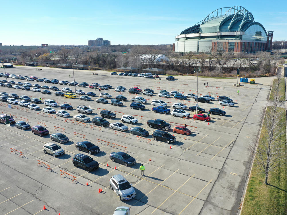 Residents line up in their cars Tuesday at a coronavirus test center on the grounds of Miller Park in Milwaukee.
