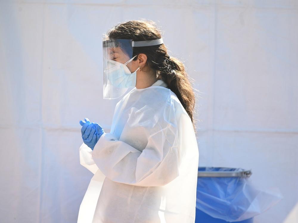 A health care worker is seen at a walk-up coronavirus testing site this week in San Fernando, Calif.