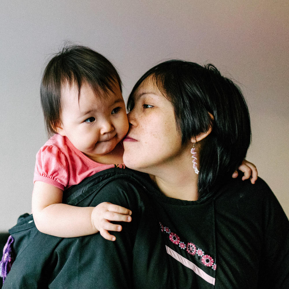 Inuit parenting is gentle and tender. They even have a special kiss for kids called <em>kunik</em>. (Above) Maata Jaw gives her daughter the nose-to-cheek Inuit sniff.