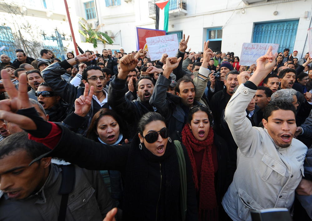People shout slogans in solidarity with residents of Sidi Bouzid during a demonstration on Dec. 27, 2010, in Tunis. The Arab Spring began that month in Tunisia, following the self-immolation of a Sidi Bouzid street vendor. Riots and demonstrations followed against unemployment and poor living conditions.