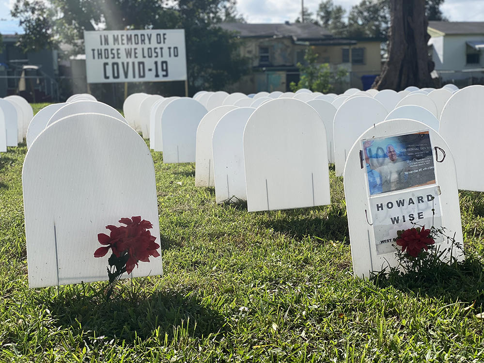 A symbolic cemetery, in memory of neighborhood residents who have died from COVID-19, stands as a memorial in a field at Simonhoff Park in the Liberty City.