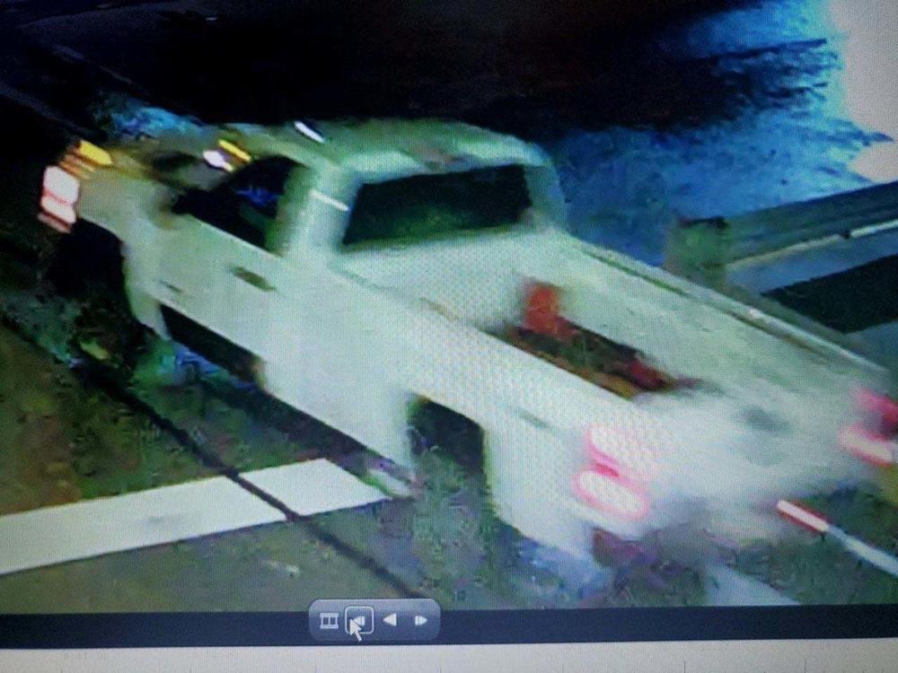 Police are looking for a white truck in connection with an incendiary device thrown from a moving vehicle, which damaged a parked car Sunday night in Pittsburgh's Lawrenceville neighborhood.