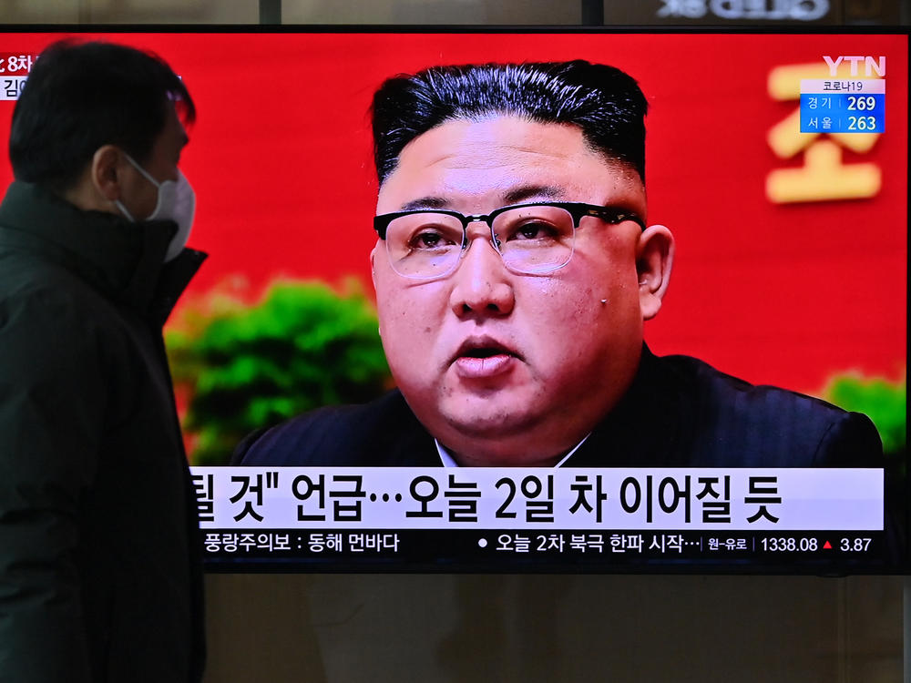 A man watches a television screen showing news footage of North Korean leader Kim Jong Un attending the 8th congress of the ruling Workers' Party held in Pyongyang, at a railway station in Seoul on Wednesday.