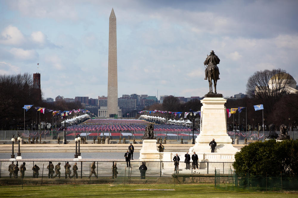 National Guard and security personnel patrol the National Mall, which has a display of nearly 200,000 flags to represent the people who could not attend the inauguration ceremonies because of the pandemic.