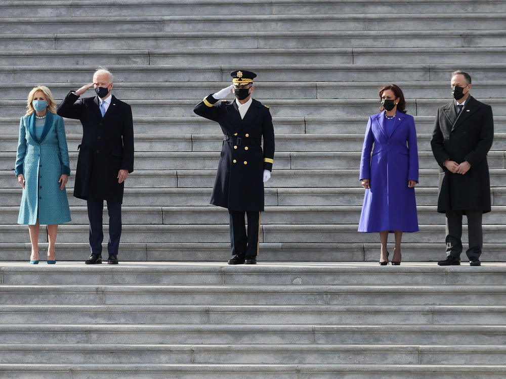 President Biden, first lady Jill Biden, Vice President Harris and second gentleman Doug Emhoff attend a Pass in Review ceremony, hosted by the Joint Task Force-National Capital Region on the East Front of the U.S. Capitol after the inauguration ceremony on Wednesday.