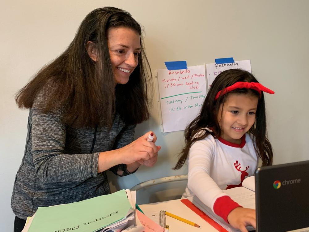Chantelly Manzanares grades her daughter Rosabella's spelling test.  Because her mother is deaf, Rosabella sometimes uses American Sign Language to interpret what's happening in her classes on Zoom.