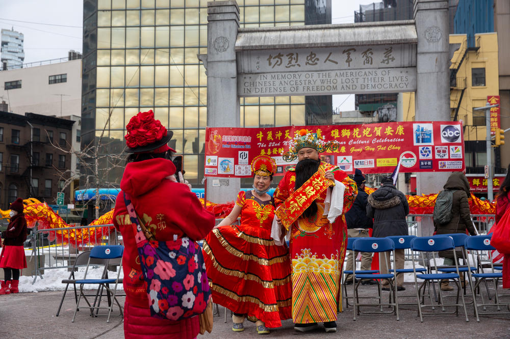 People take photos at the Lunar New Year celebration in Kimlau Memorial Square.