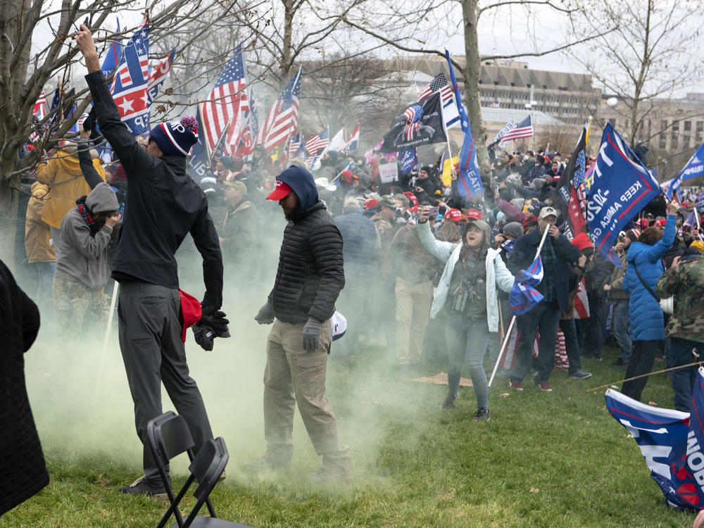Supporters of former President Donald Trump protest as U.S. Capitol Police officers shoot tear gas outside of the U.S. Capitol on Jan. 6.