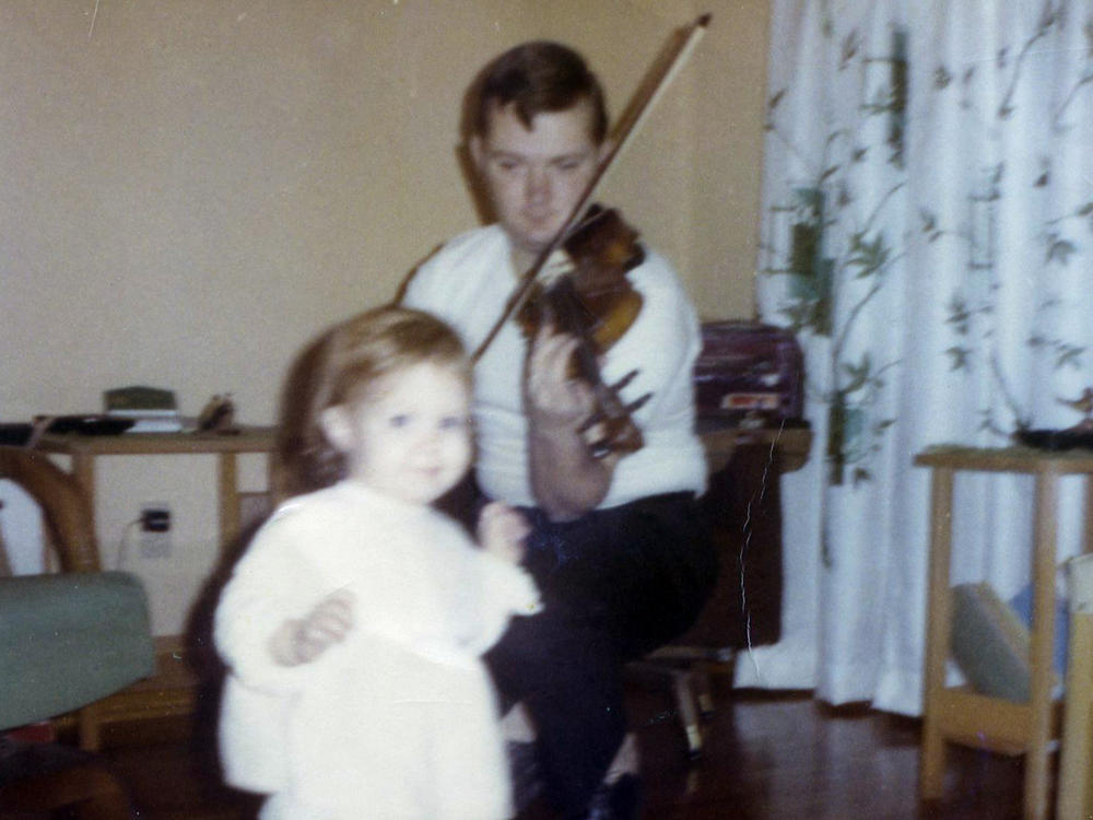 A young Jack Ranney, of Champaign, Ill., plays the violin for his daughter, Jillian. Jack died Nov. 23, 2020, at the age of 80 from COVID-19.