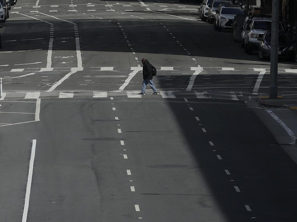 A man crosses a nearly empty street in San Francisco, on March 17, 2020. Despite a reduction in driving last year, road fatalities increased, according to the National Safety Council.