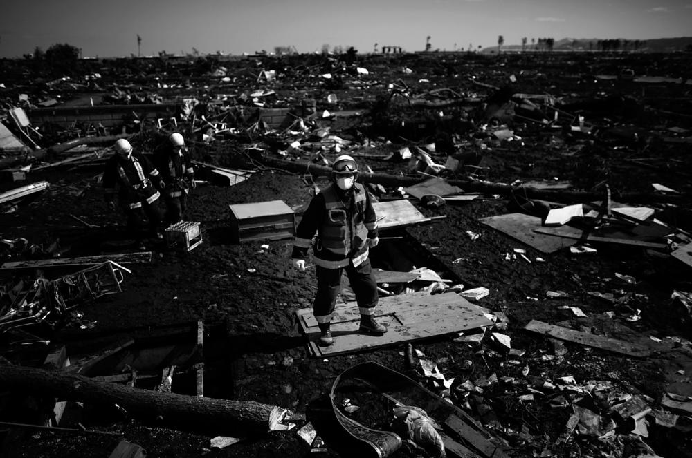 A firefighter stands amid what little remains of the coastal town of Noda, Iwate Prefecture, in northeastern Japan, March 18, 2011. Noda was almost completely destroyed by the earthquake and tsunami.