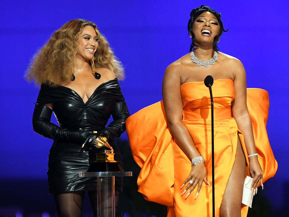 Beyoncé (left) and Megan Thee Stallion, who each won three awards at the 2021 Grammy Awards, accept trophy for best rap performance on March 14, 2021 in Los Angeles, Calif.
