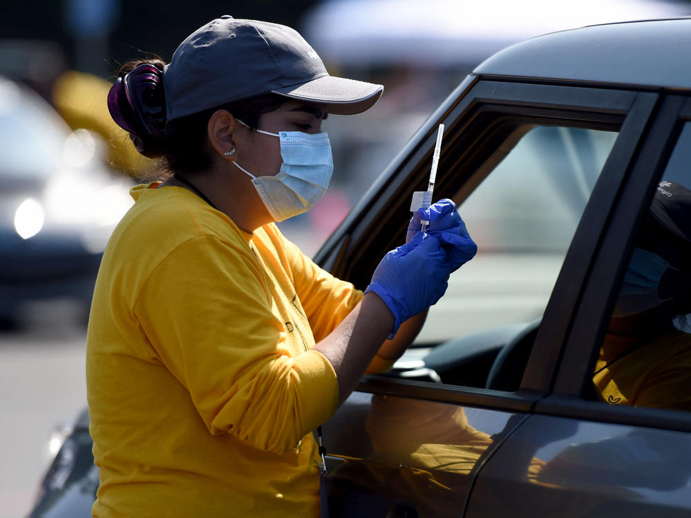 A worker prepares to give a COVID-19 vaccine last week at the Dignity Health Sports Park in Carson, Calif.