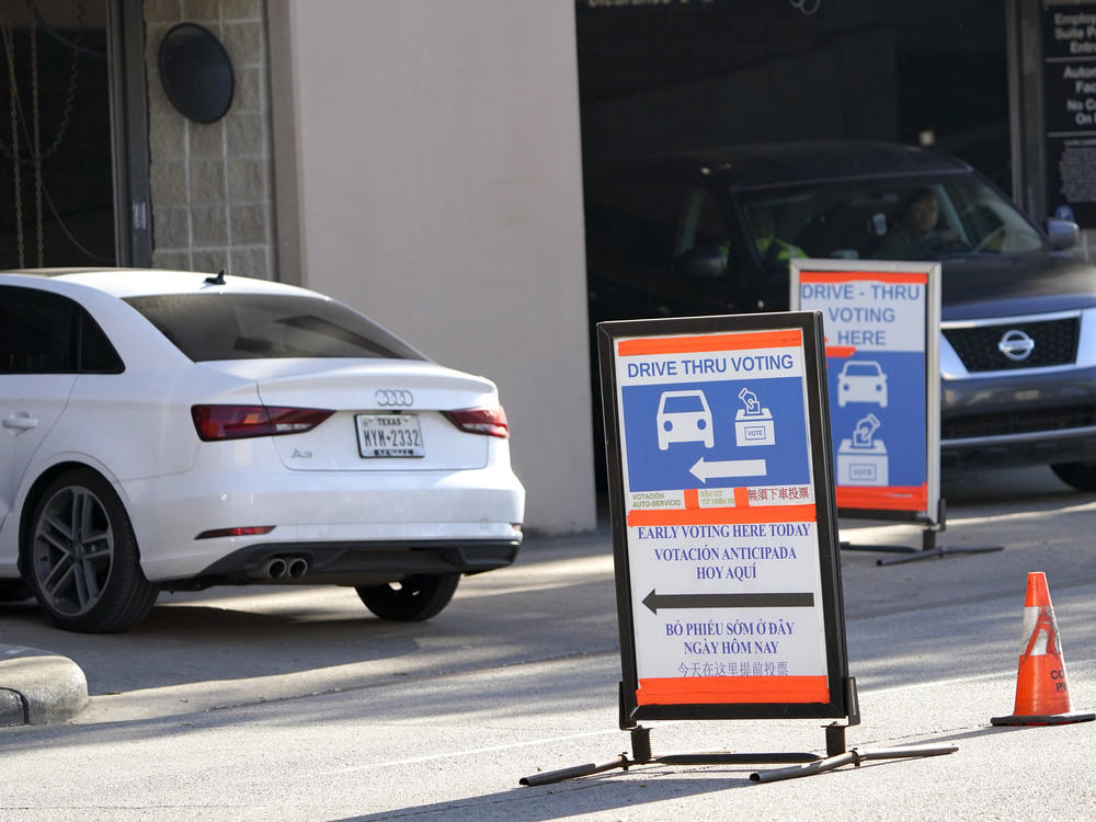 Cars enter and leave a drive-thru voting site in Houston on Election Day in 2020. Texas Republican lawmakers are looking to ban the practice.
