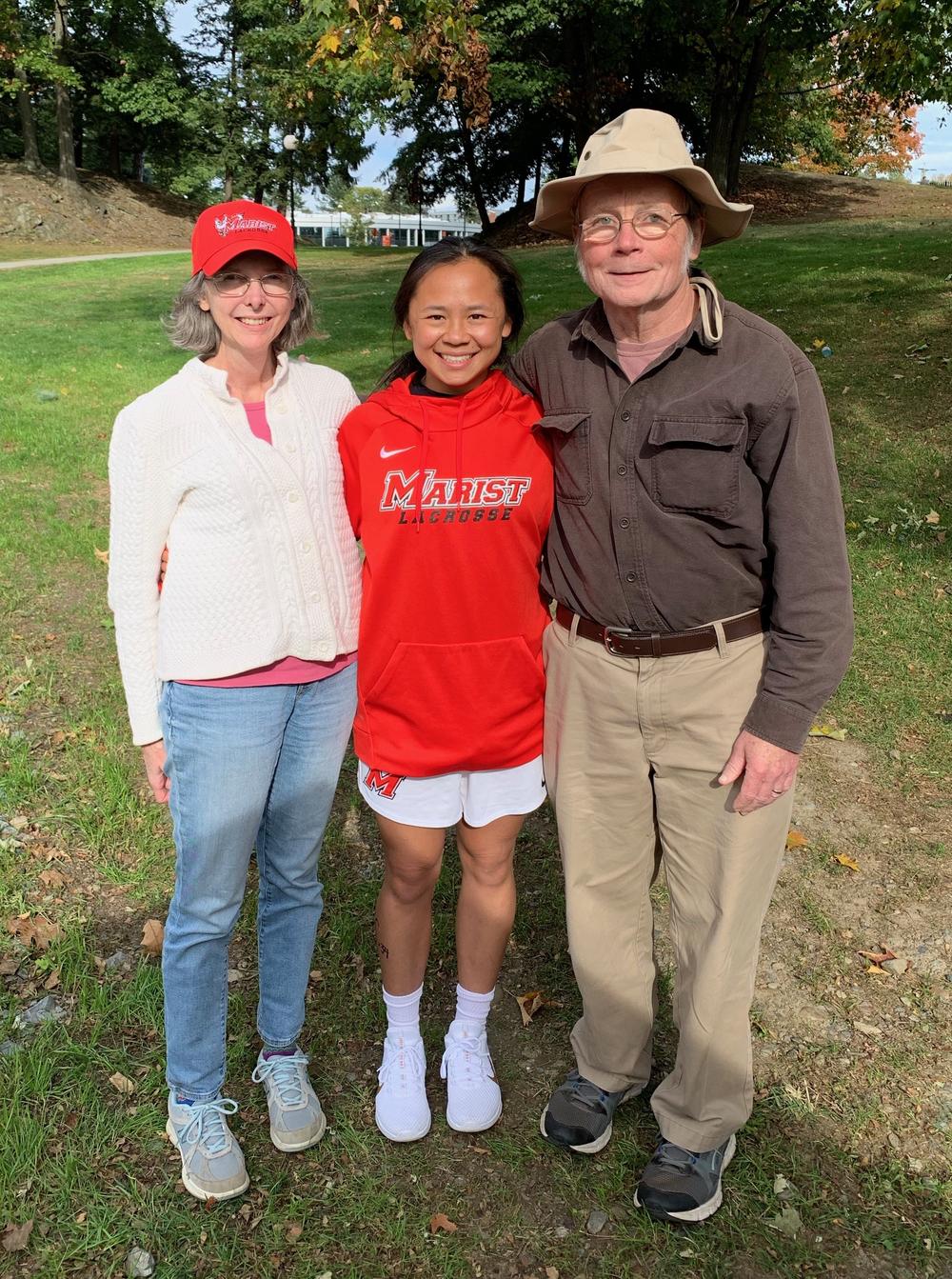 Emma LeMay with her parents, Lisa and John, in 2019.