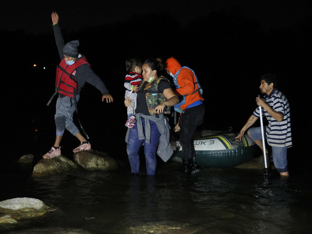A group of migrants from El Salvador arrives in Roma, Texas, after crossing the Rio Grande on March 30, 2021 in Roma, Texas.