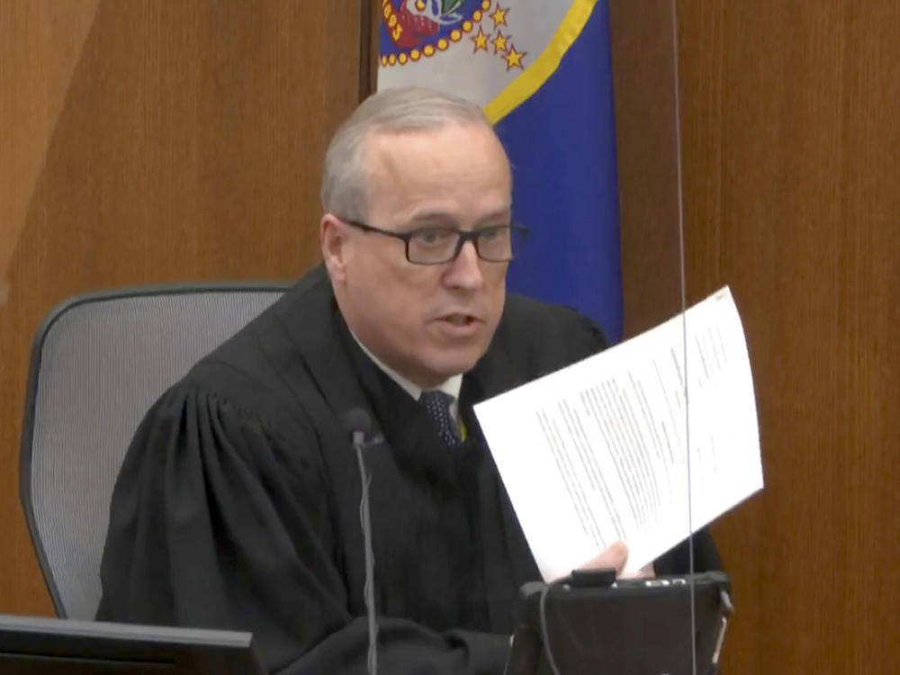 In an image taken from video on Monday, Hennepin County Judge Peter Cahill reads instructions to the jury before closing arguments in the trial of former Minneapolis police officer Derek Chauvin.