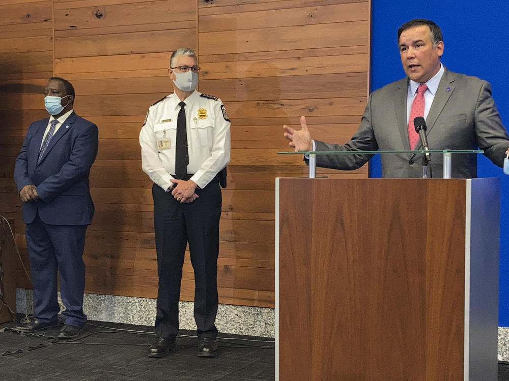 Columbus, Ohio, Mayor Andrew Ginther speaks during a news conference Wednesday about the fatal police shooting of 16-year-old Ma'Khia Bryant on Tuesday. Columbus Public Safety Director Ned Pettus (left) and interim Police Chief Michael Woods listen.